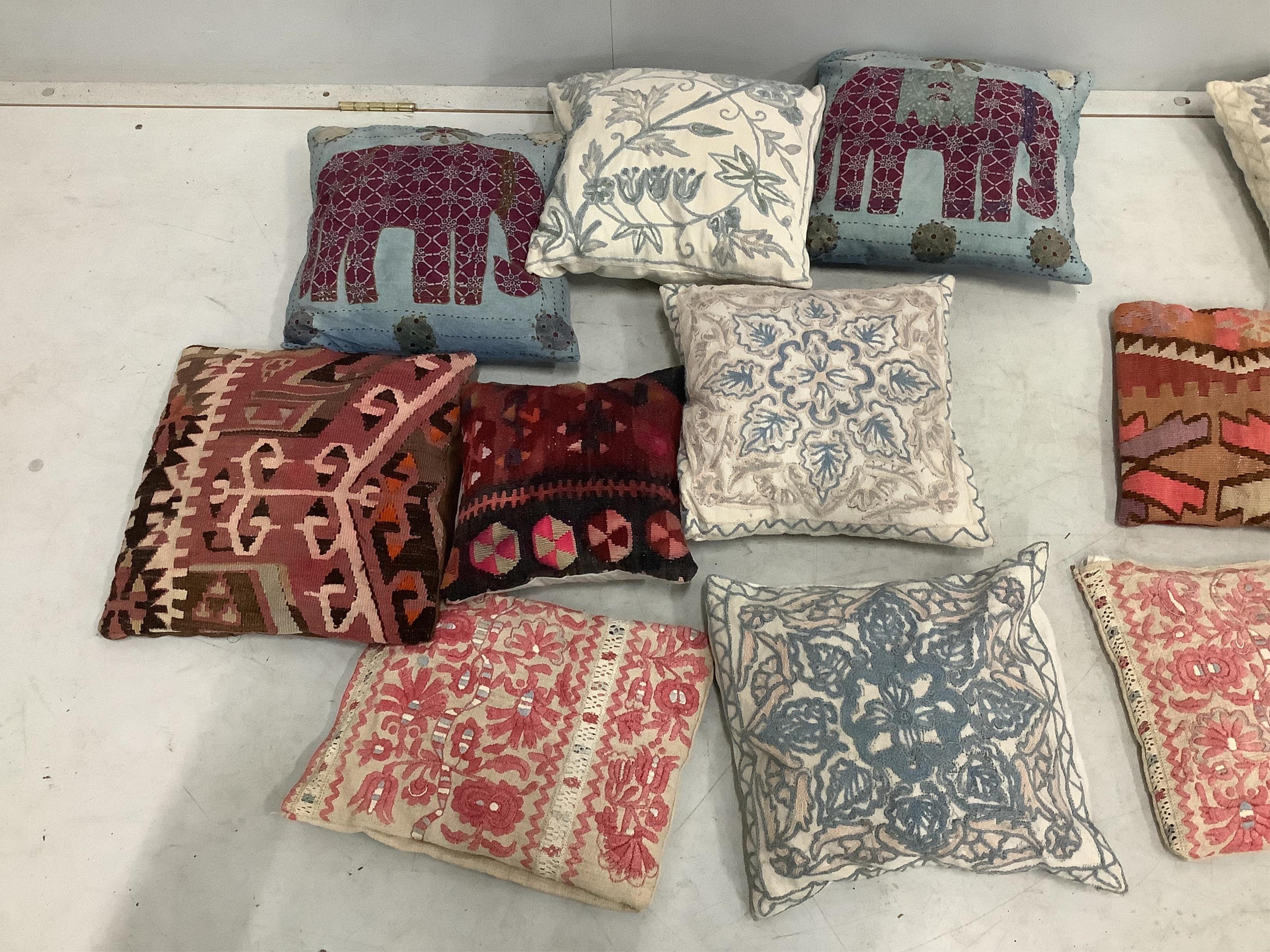 A collection of sixteen Kilim and other embroidered cushions, largest 38 x 35cm. Condition - fair